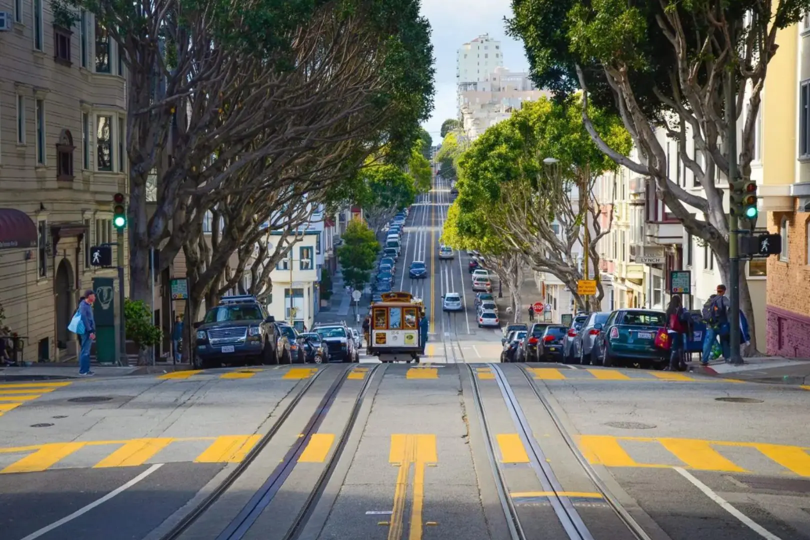 A street with cars and a tram on it