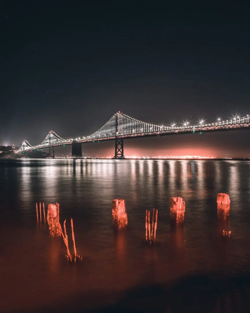 A night time picture of the bay bridge.